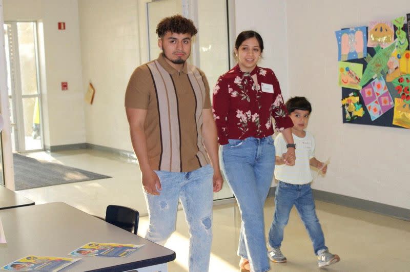 Genaro Vicencio, an immigrant from Mexico, walks with his American wife Cindy Maduena and their son Israel