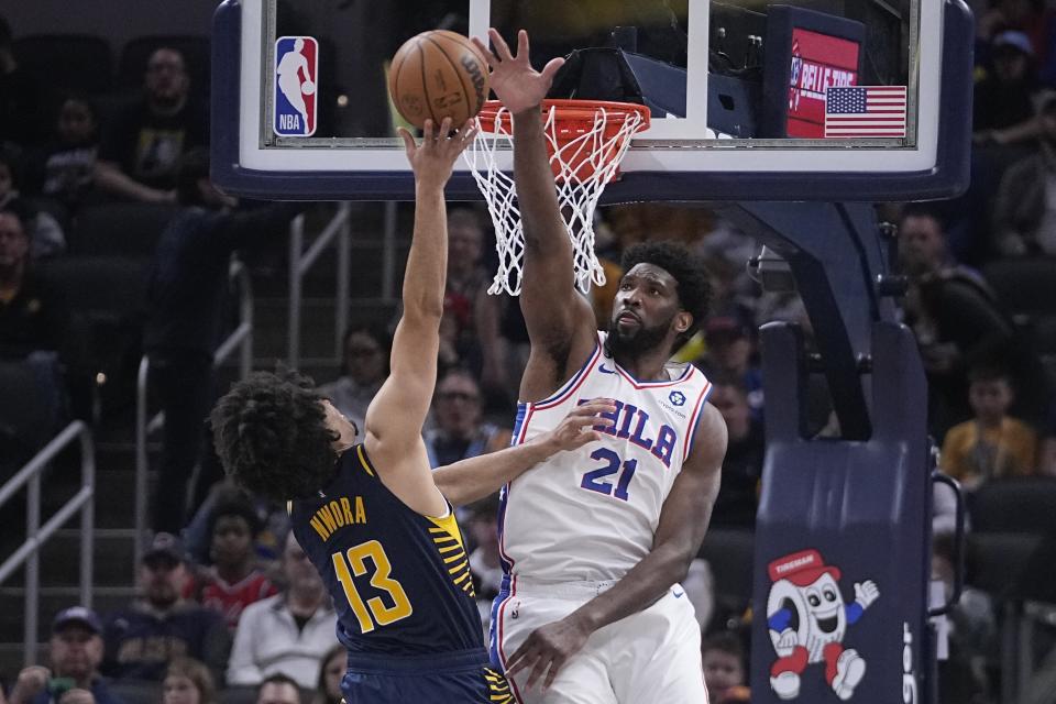 Indiana Pacers' Jordan Nwora (13) has his shot blocked by Philadelphia 76ers' Joel Embiid (21) during the second half of an NBA basketball game, Monday, March 6, 2023, in Indianapolis. (AP Photo/Darron Cummings)