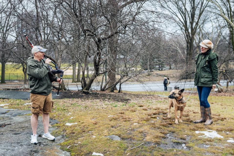 Lt. Robert Walsh, of FDNY EMS Station 10 and a bagpiper for the FDNY EMS Pipes and Drums band, serenades Agnese Neil and her dog, Mia, in Central Park on Feb 23. Emmy Park for N.Y.Post