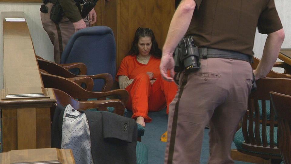 Taylor Schabusiness sits on the floor of a Brown County courtroom after attacking her attorney, Quinn Jolly, during a court hearing in Green Bay, Wis., on Tuesday, Feb. 14, 2023 (AP)