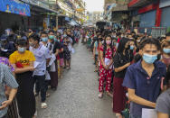 FILE - In this Dec. 20, 2020, file photo, people stand in lines to get COVID-19 tests in Samut Sakhon, south of Bangkok. Thailand’s lucky streak faded late last year, when a virus cluster was found among migrant workers working in factories and seafood markets and living in crowded dormitories. Severe restrictions and a massive testing campaign near the outbreak's epicenter seemed to contain it after several weeks. (AP Photo/Jerry Harmer, File)