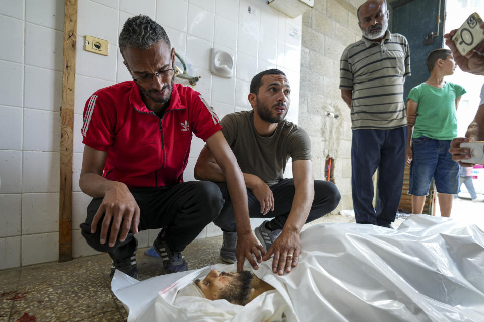Palestinians react next to the bodies of their relatives who were killed in an Israeli airstrike in Gaza Stirp, at the Al Aqsa hospital in Deir al Balah, Gaza, Saturday, May 4, 2024. (AP Photo/Abdel Kareem Hana)
