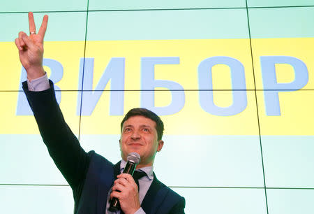 FILE PHOTO: Ukrainian comic actor and presidential candidate Volodymyr Zelenskiy flashes a victory sign following the announcement of the first exit poll in a presidential election at his campaign headquarters in Kiev, Ukraine March 31, 2019. REUTERS/Valentyn Ogirenko/File Photo