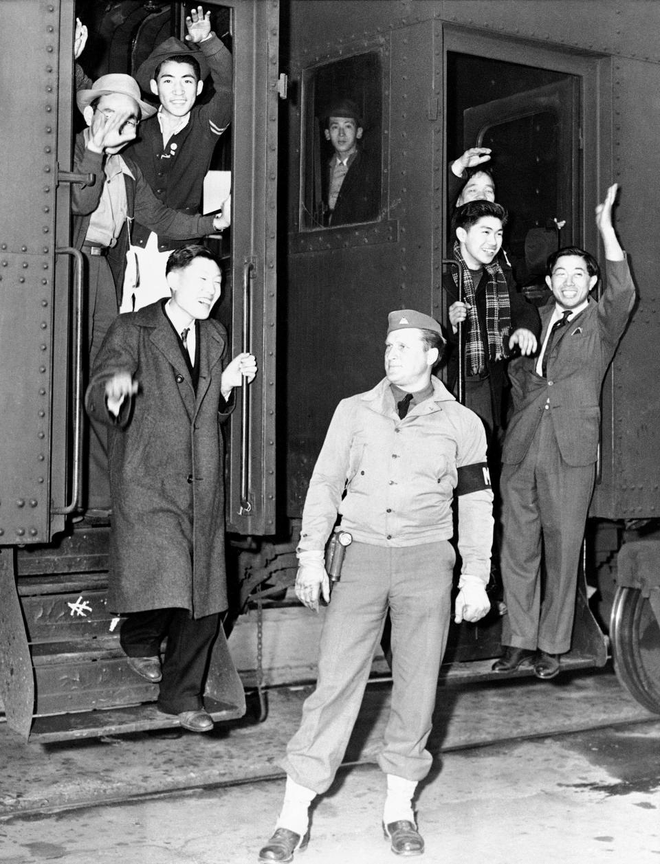 FILE - In this March 23, 1942, file photo, young Japanese, members of the first mass migration from Los Angeles for the war's duration, wave goodbye from the steps of an army train taking them to the reception center being built at Manzanar, Calif. (AP Photo, File)