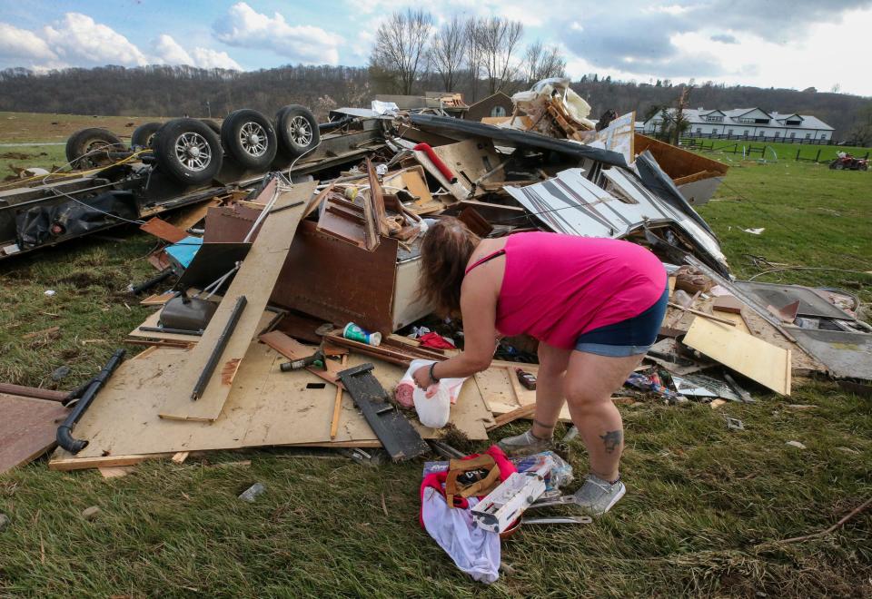 Michelle Braden tries to salvage belongings from a friend’s RV. There was damage to many homes and travel trailers in Milton, Kentucky, after a tornado touched down on Thursday, March 14, 2024