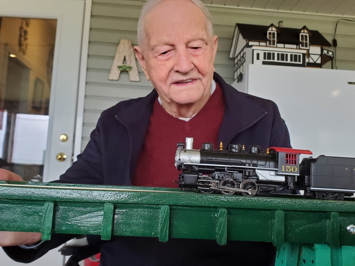 Gunnar Pedersen turned 100 in early September. He spent much of the last year working on a model replica of the Salmon River Trestle that stretches out on the horizon near the New Denmark farmhouse he lived in since he was five. (Shane Fowler/CBC - image credit)