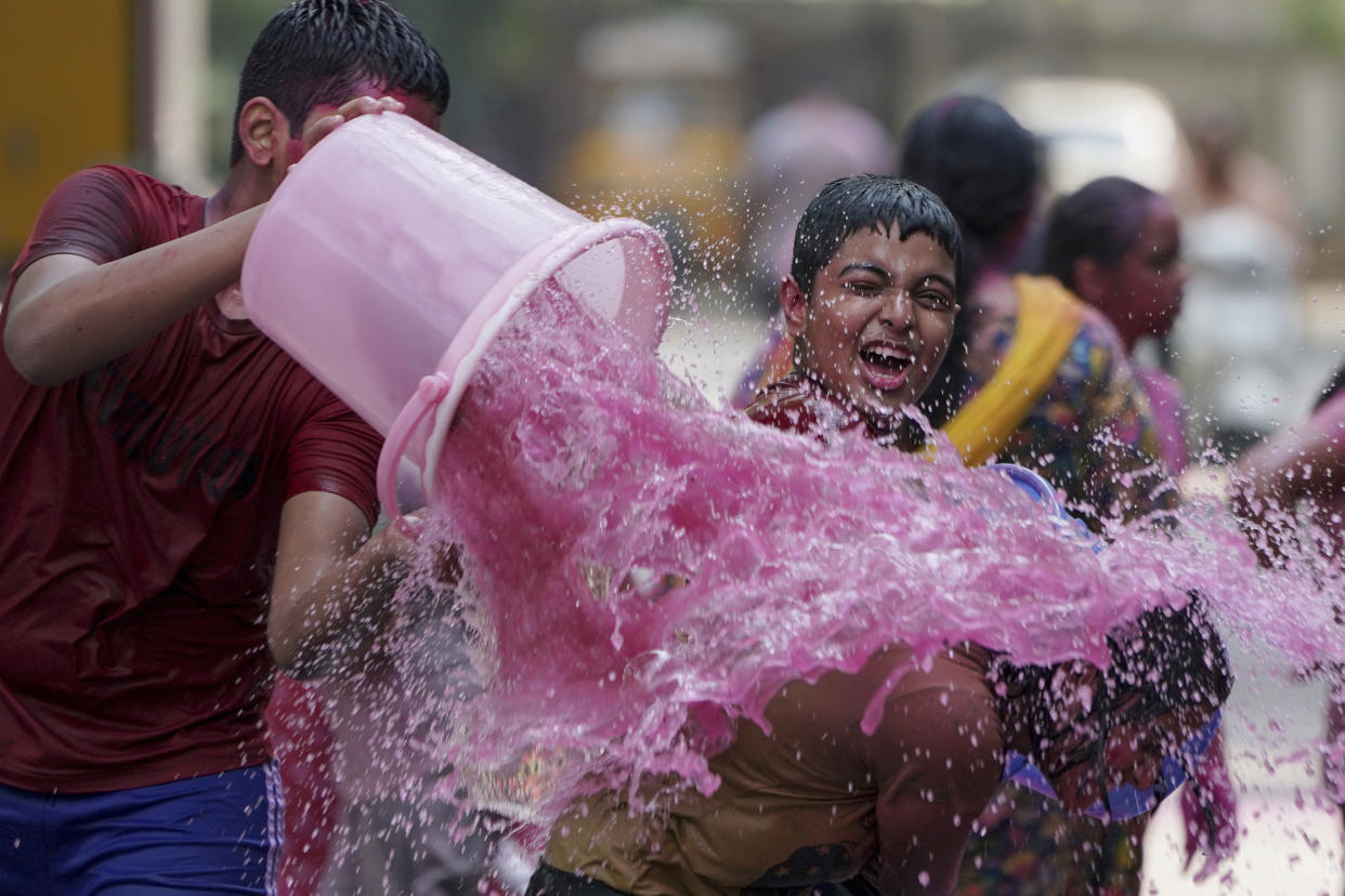 Children play with color water as they celebrate Holi, the Hindu festival of colors, in Hyderabad, India, Tuesday, March 7, 2023.(AP Photo/Mahesh Kumar A.) ,