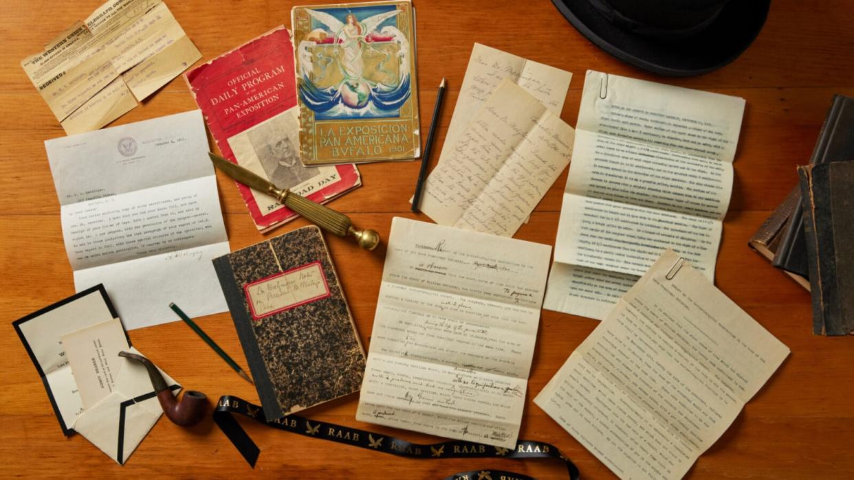  A collection of letters, notebooks and other documents lying on a table. 