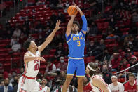 UCLA guard Johnny Juzang (3) shoots as Utah guard Marco Anthony (10) defends during the first half of an NCAA college basketball game Thursday, Jan. 20, 2022, in Salt Lake City. (AP Photo/Rick Bowmer)