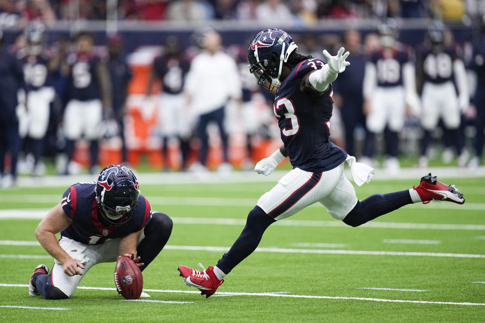 Houston Texans' Dare Ogunbowale (33), with Cameron Johnston (11) holding, kicks a field goal against the Tampa Bay Buccaneers during the second half of an NFL football game, Sunday, Nov. 5, 2023, in Houston. (AP Photo/Eric Gay)