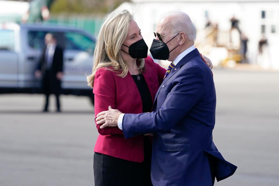 President Joe Biden hugs Rep. Abigail Spanberger, D-Va., as he arrives on Marine One at Culpeper Regional Airport, Thursday, Feb. 10, 2022, in Brandy Station, Va.