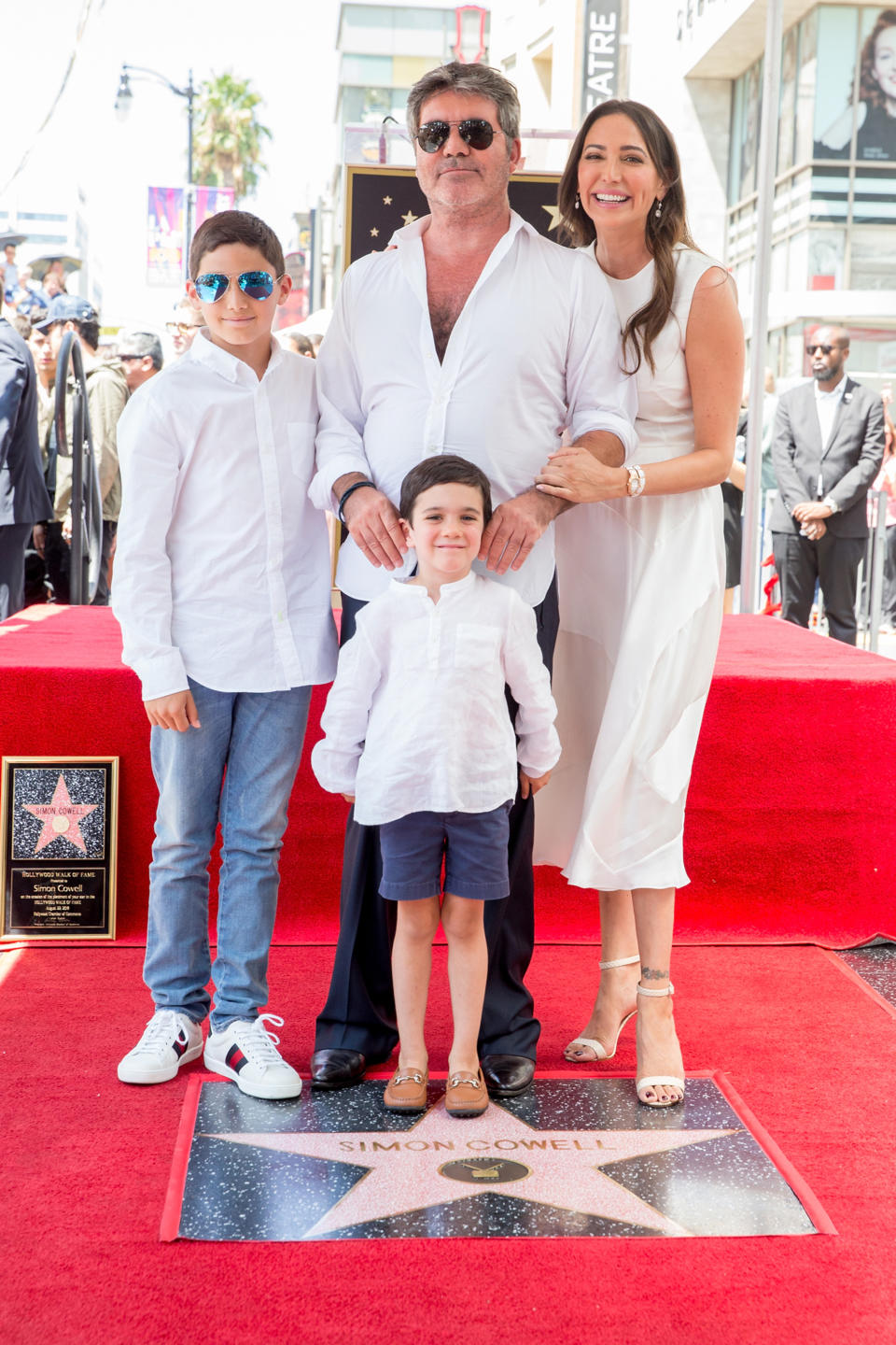 Simon Cowell with partner Lauren Silverman, their son, Eric, center, and her son, Adam. Yes, the boys wore white button-downs just like Simon, who is never without one. (Photo: Rich Fury/Getty Images)