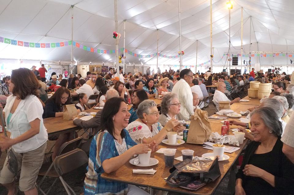 The main tent at the 2015 Cristo Rey Fiesta is jammed with people enjoying their lunches.