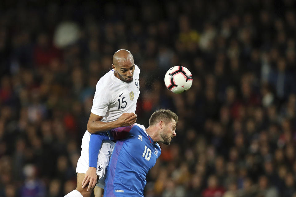 France's Steven Nzonzi, left, and Iceland's Gylfi Sigurdsson, challenge to head the ball during a friendly soccer match between France and Iceland, in Guingamp, western France, Thursday, Oct. 11, 2018. (AP Photo/David Vincent)