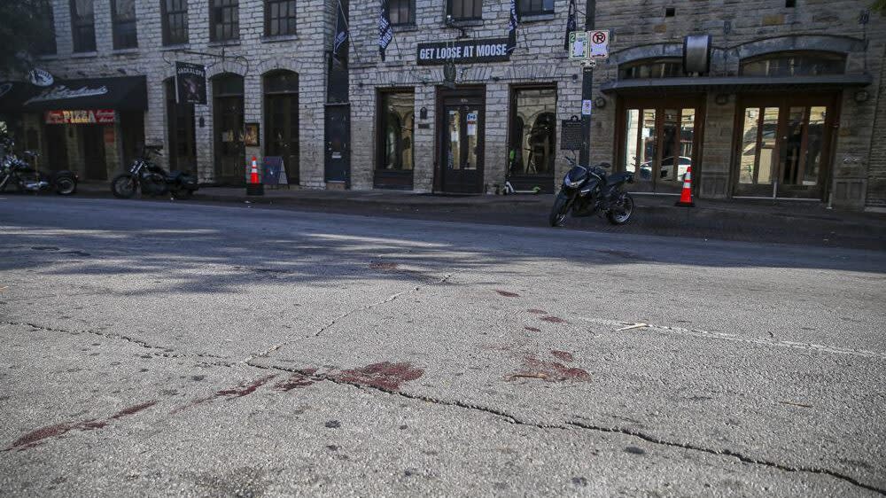 Blood stains remain on 6th Street after an early morning shooting on Saturday, June 12, 2021 in downtown Austin, Texas. (Aaron Martinez/Austin American-Statesman via AP)