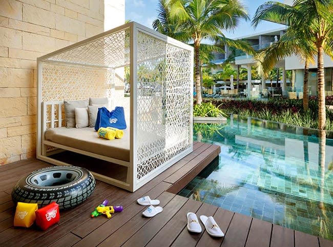 Family Suite with a white Cabana with a childrens rubber ring inflatable, armbands and two pairs of childrens mini slippers