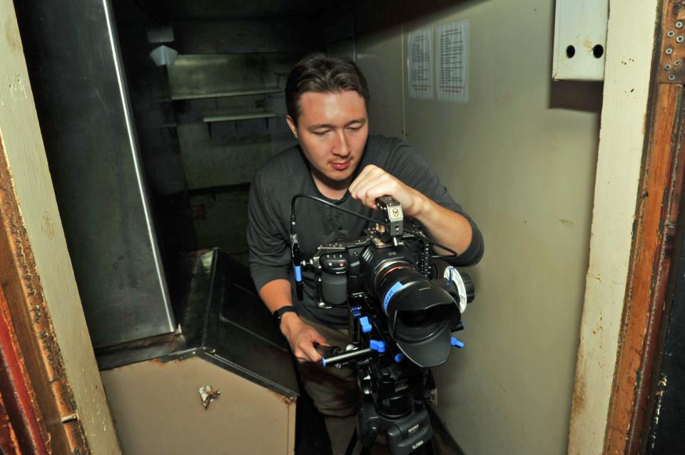 Cinematographer JC Stewart, of Hingham, adjusts his camera to begin filming a scene of the movie "St. Jones' Ditch" at the former Squires restaurant in Hanover.