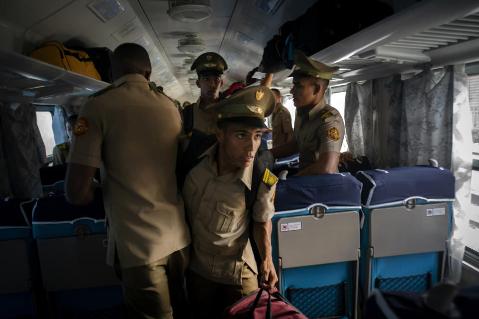 Cadets board the first train using new equipment from China, in Havana, Cuba, Saturday, July 13, 2019. The first train using new equipment from China pulled out of Havana Saturday, hauling passengers on the start of a 915-kilometer (516-mile) journey to the eastern end of the island as the government tries to overhaul the country’s aging and decrepit rail system. (AP Photo/Ramon Espinosa)