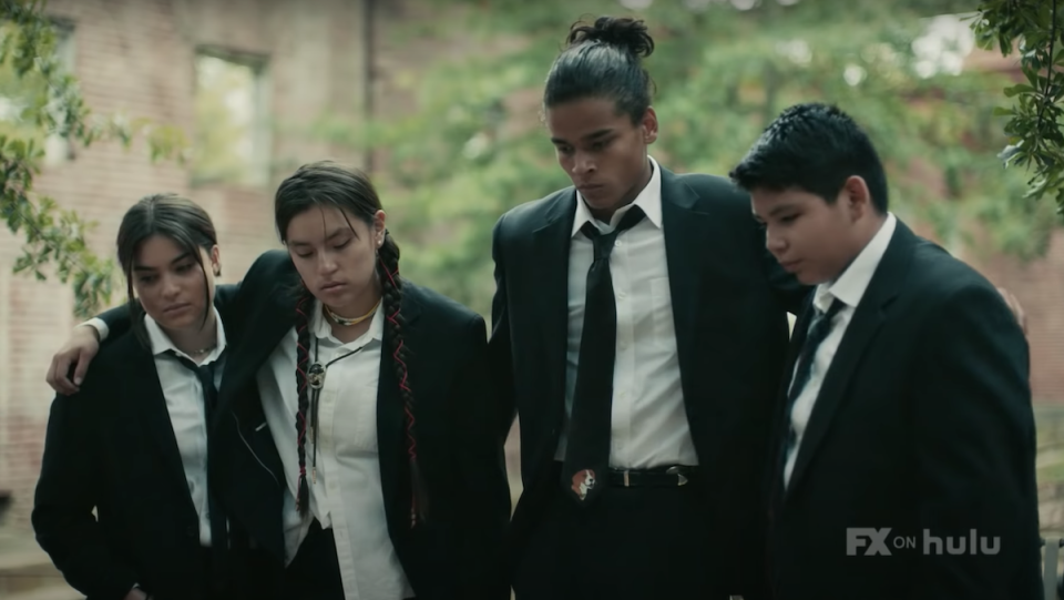 Four Indigenous teens wear suits and ties in the style of Reservoir Dogs.