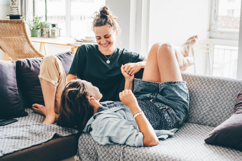 two women on the couch talking