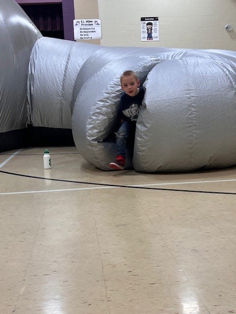 Liam Diehl, a second-grader at B.L. Miller Elementary School in Sebring, climbs out of the inflatable planetarium called Sky Dome on Thursday, April 11, 2024.