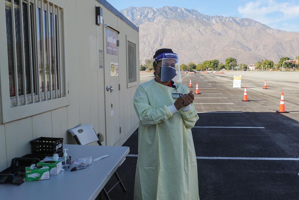 Alyssa Young sanitizes her hands after administering a Covid-19 test for Covid Clinic in an overflow parking lot at Palm Springs International Airport, January 5, 2021. 
