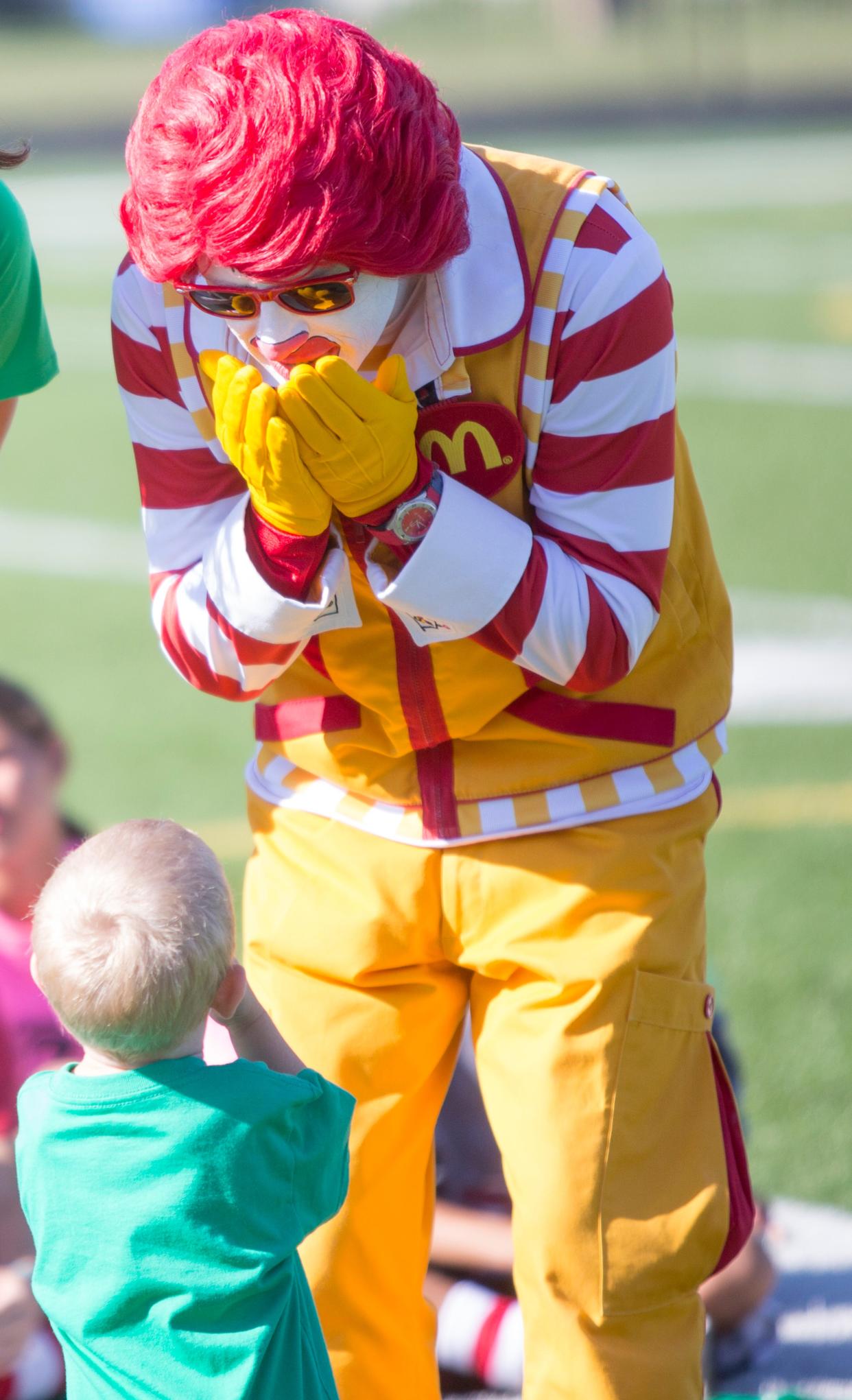 Ronald McDonald interacts with a kid at St. Joseph High School, Tuesday, July 26, 2016 in South Bend. The event was put together to announce a donation from the Kelly Cares Foundation to the Ronald McDonald House Charities.