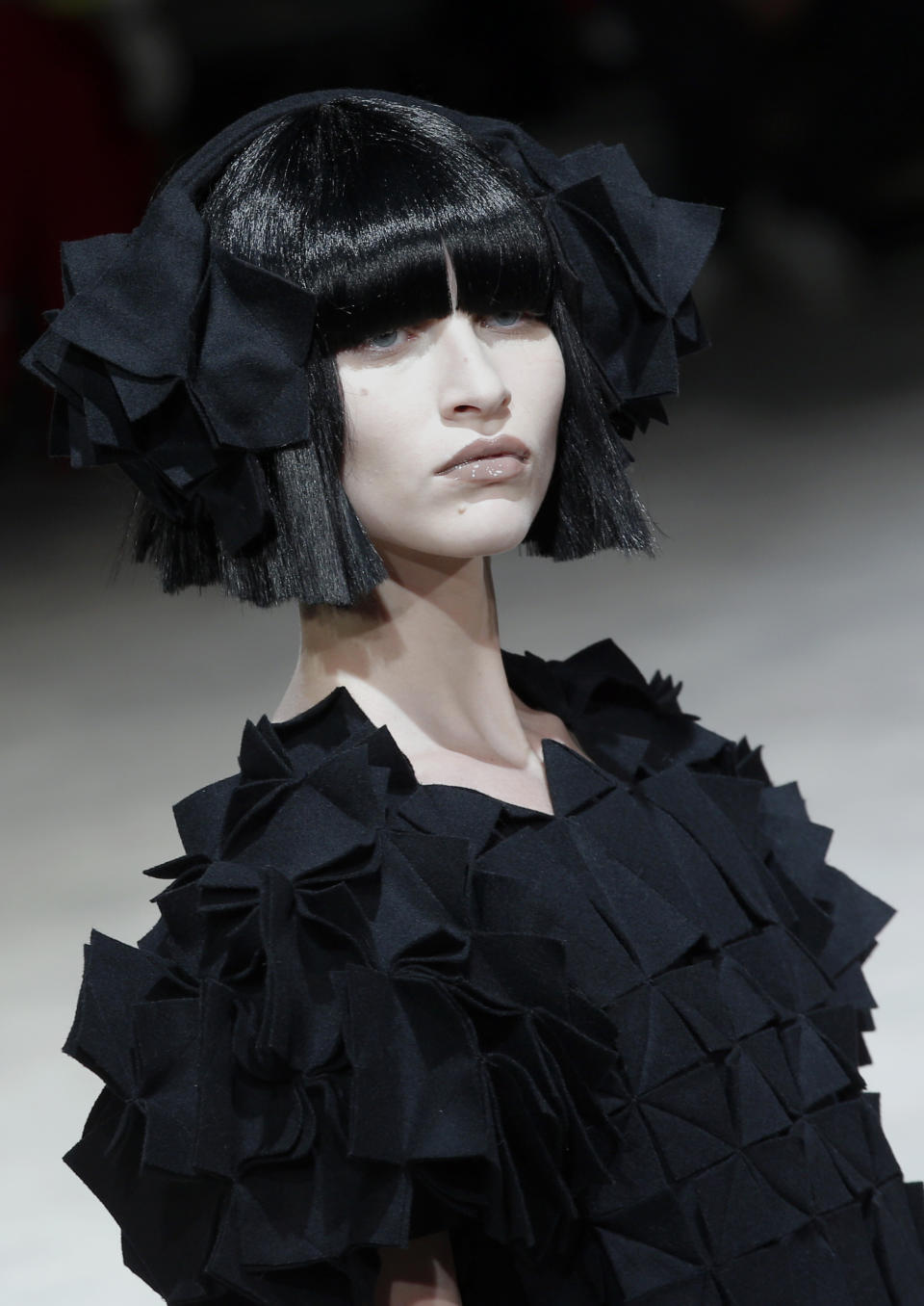 A model wears a creation by Japanese fashion designer Yohji Yamamoto for his Fall/Winter 2013-2014 ready to wear collection, in Paris, Friday, March 1, 2013. (AP Photo/Christophe Ena)