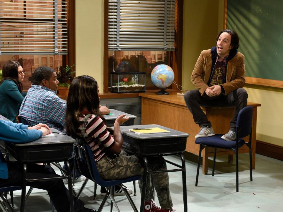 Lin-Manuel Miranda acts in character as a teacher in front of a classroom in a Saturday Night live sketch.
