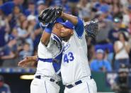 Jul 21, 2018; Kansas City, MO, USA; Kansas City Royals relief pitcher Wily Peralta (43) is congratulated by catcher Salvador Perez (13) after the win over the Minnesota Twins at Kauffman Stadium. The Royals won 4-2. Mandatory Credit: Denny Medley-USA TODAY Sports