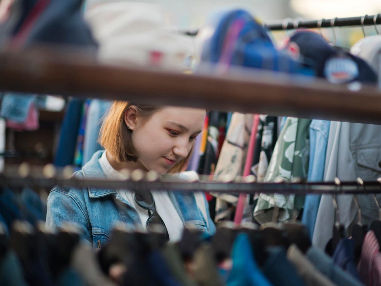 Young girl shopping in a second hand market in summer, zero waste concept