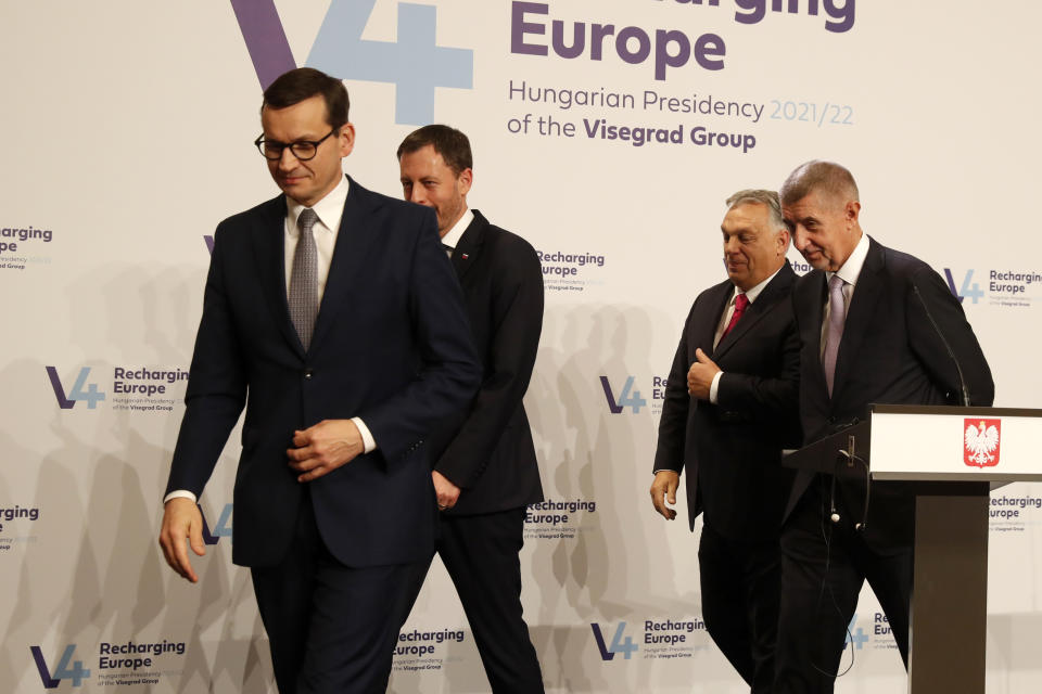 From left: Prime Ministers Mateusz Morawiecki of Poland, Eduard Heger of Slovakia, Viktor Orban of Hungary and Andrej Babis of the Czech Republic walk away after a news briefing in Budapest, Hungary, Tuesday, Nov. 23, 2021. The leaders of the Visegrad Four group of Central European countries met in Hungary's capital of Budapest Tuesday to discuss the ongoing migration crisis along Poland's border with Belarus. (AP Photo/Laszlo Balogh)