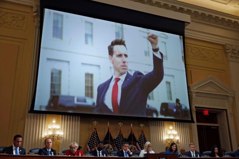 An image of Josh Hawley raising his fist on January 6 is projected during a House committee hearing