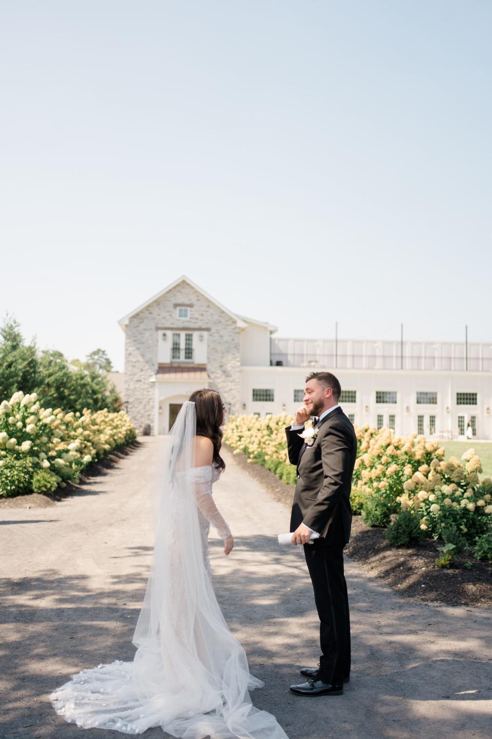 A bride and groom look at each other on their wedding day.