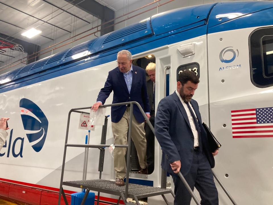 Senate Majority Leader Chuck Schumer and Transportation Under Secretary Carlos Monje Jr. step off a new Acela high-speed train built in Hornell during a Tuesday visit.