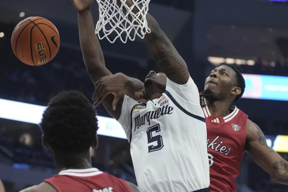 Northern Illinois's Harvin Ibarguen fouls Marquette's Tre Norman during the first half of an NCAA college basketball game Monday, Nov. 6, 2023, in Milwaukee. (AP Photo/Morry Gash)