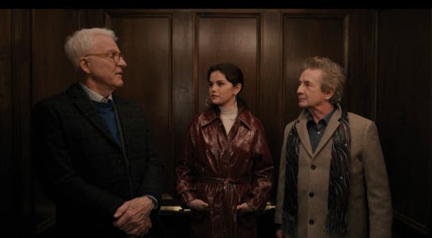 Charles-Haden, Mabel in her detective trench and Oliver leave the building.<p>Screenshot: 'Only Murders in the Building' on Hulu</p>
