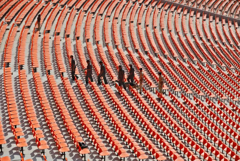 Members of bomb disposal squad from Gujarat Police scan the stands at Sardar Patel Gujarat Stadium event in Ahmedabad