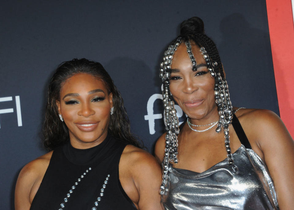 Serena and Venus posing on a red carpet