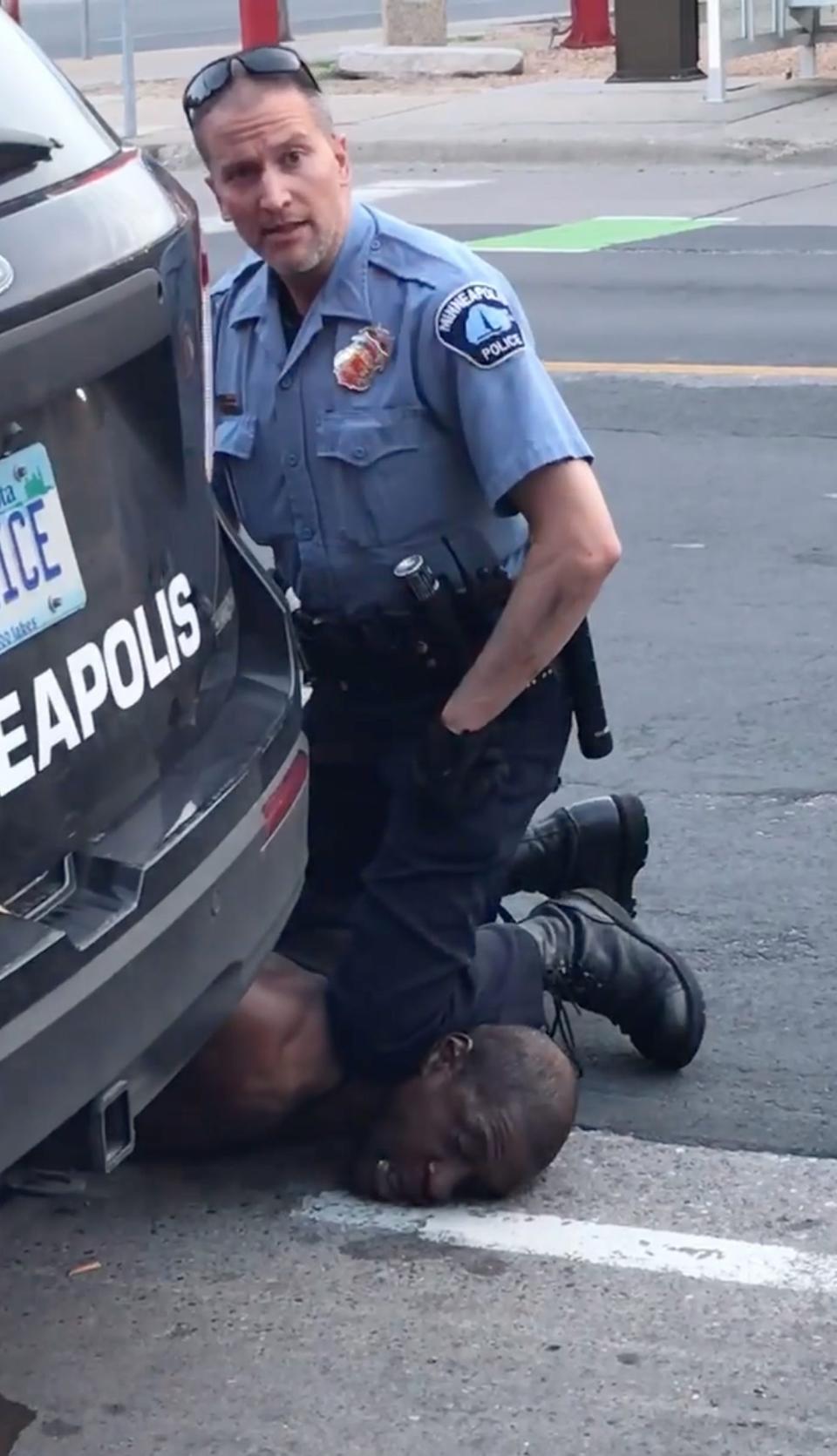 Minneapolis police officer Derek Chauvin kneels on George Floyd on May 25, 2020. Chauvin, who was convicted of murder in Floyd's death, looked directly into bystanders' cameras.