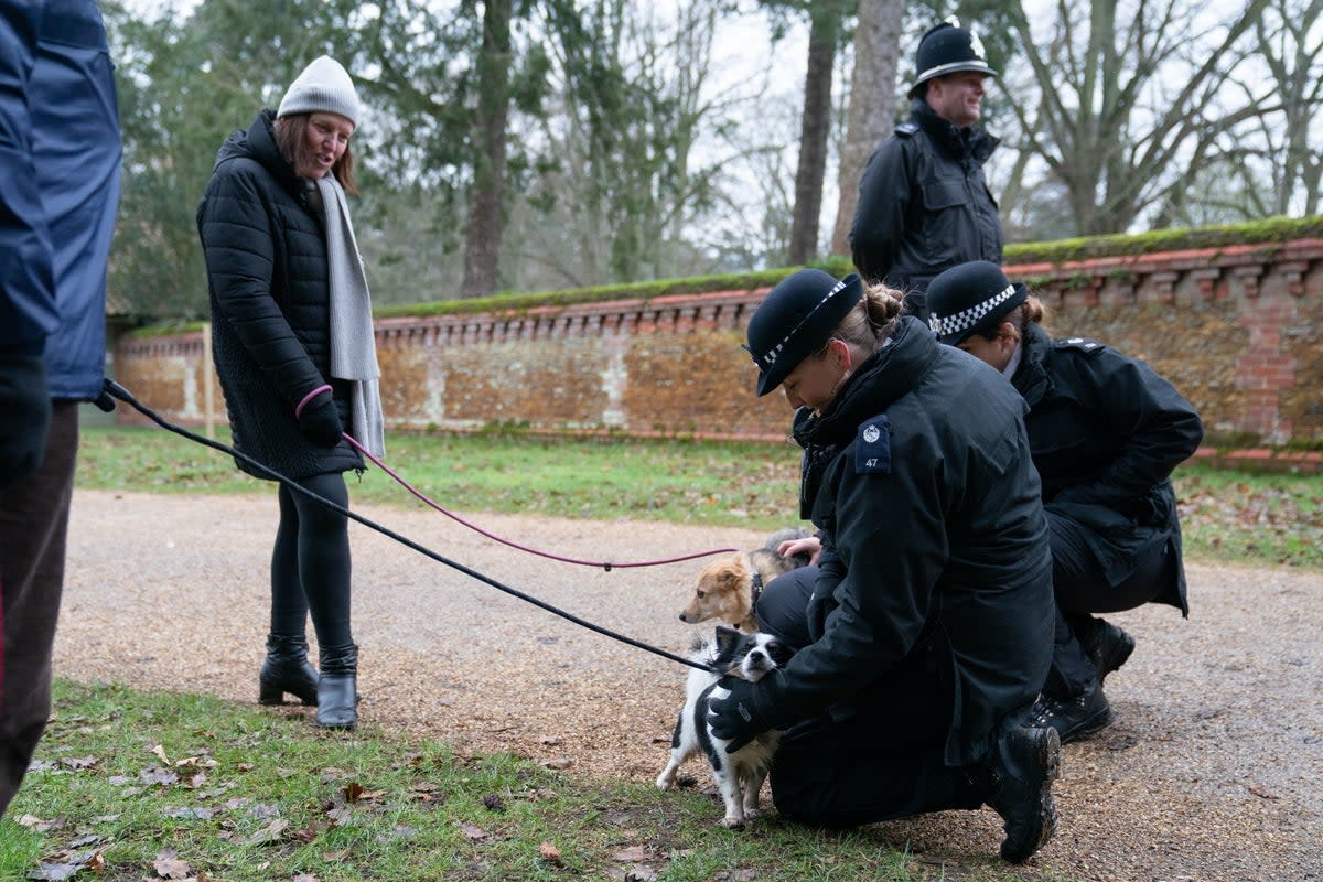 29 January 2023: Passersby chat with the police as they arrive to see King Charles III and the Princess Royal attend a church service at St Mary Magdalene Church in Sandringham, Norfolk (PA)