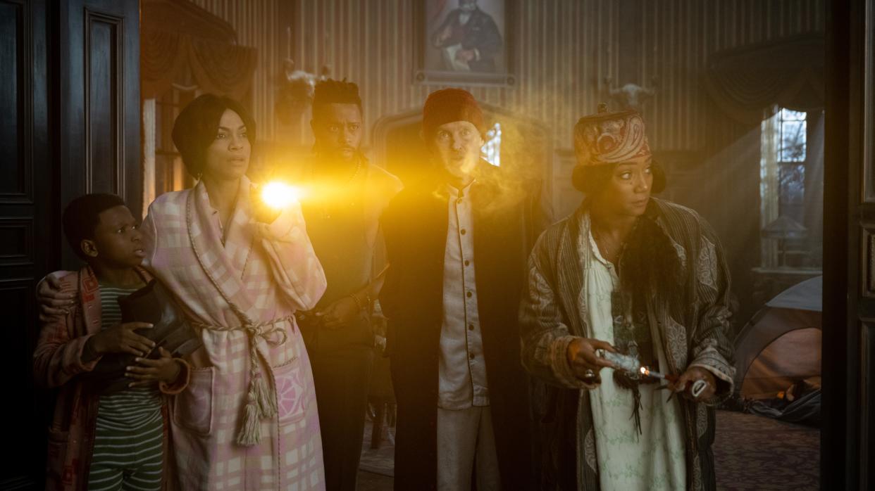 Chase Dillon, from left, stars as Travis, Rosario Dawson as Gabbie, LaKeith Stanfield as Ben, Owen Wilson as Father Kent, and Tiffany Haddish as Harriet in "Haunted Mansion."