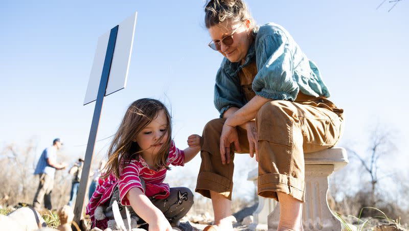 Kimberly Vanderburg-Murphy shows Lilinoe Arvin, 3, a memorial for her daughter Hali Vanderburg-Murphy at the Og-Woi People’s Garden in Salt Lake City on April 10.