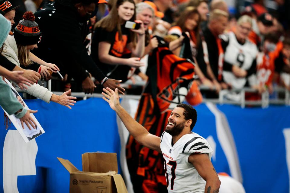 Cincinnati Bengals tight end C.J. Uzomah (87) celebrates with a row of Bengals fans after the fourth quarter of the NFL Week 6 game between the Detroit Lions and the Cincinnati Bengals at Ford Field in Detroit on Sunday, Oct. 17, 2021. The Bengals held the lead the entire game and finished with a 34-11 win in Detroit. 