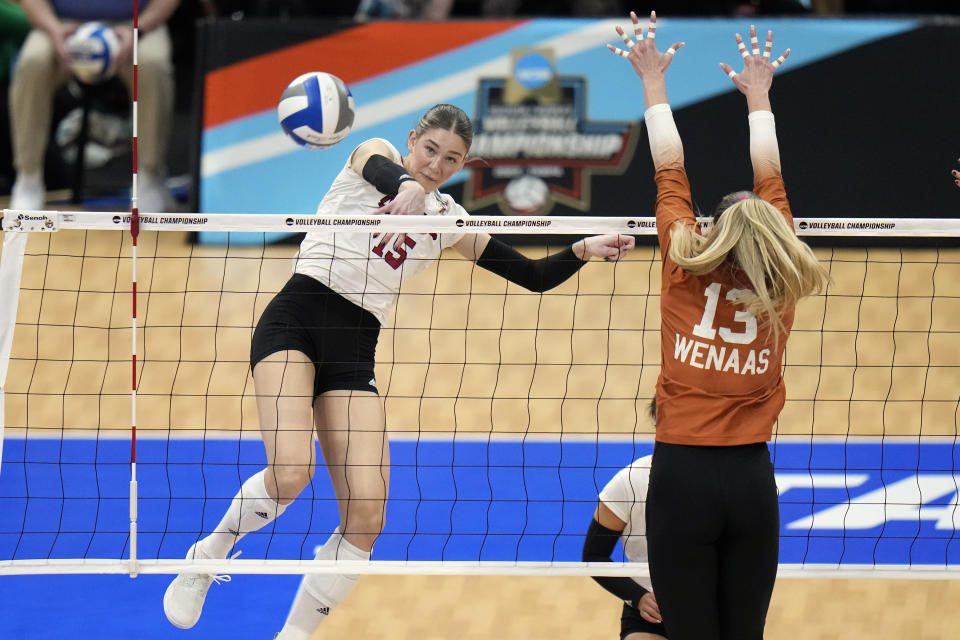 Nebraska's Andi Jackson (15) scores past Texas's Jenna Wenaas (13) during the championship match in the NCAA Division I women's college volleyball tournament Sunday, Dec. 17, 2023, in Tampa, Fla. (AP Photo/Chris O'Meara)