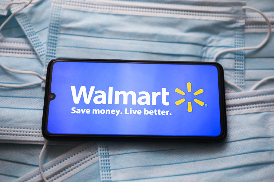 Walmart logo is displayed on a mobile phone screen photographed on surgical masks background for illustration photo during the coronavirus pandemic. Gliwice, Poland on April 21, 2021.  (Photo by Beata Zawrzel/NurPhoto via Getty Images)