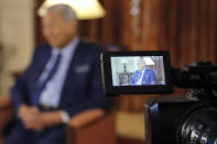 CORRECTS SPELLING OF PRIME MINISTER'S NAME - Malaysia's Prime Minister Mahathir Mohamad is pictured through an electronic viewfinder during an interview with The Associated Press in Putrajaya, Malaysia, Monday, Aug. 13, 2018. Mahathir said he will seek to cancel multibillion-dollar Chinese-backed infrastructure projects that were signed by his predecessor as his government works to dig itself out of debt, and he blasted Myanmar’s treatment of its Rohingya minority as "grossly unjust." (AP Photo/Yam G-Jun)