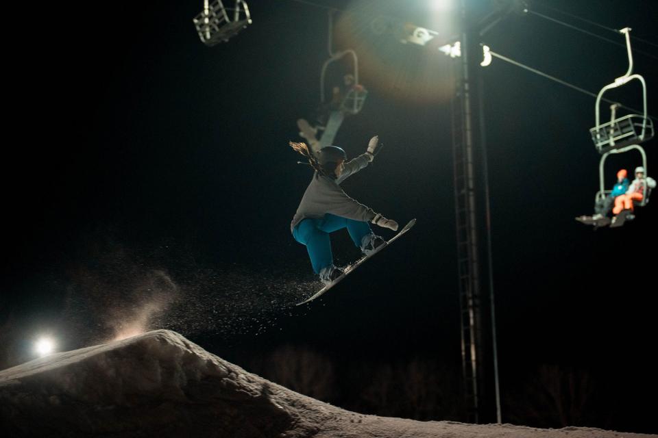 A snowboarder gets some good air during an evening at Seven Oaks recreation area in Boone, Iowa.