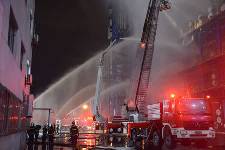 Firefighters spray water onto a fire at state oil major PetroChina's plant in Dalian, Liaoning province, China August 17, 2017. CNS/Yang Yi via REUTERS