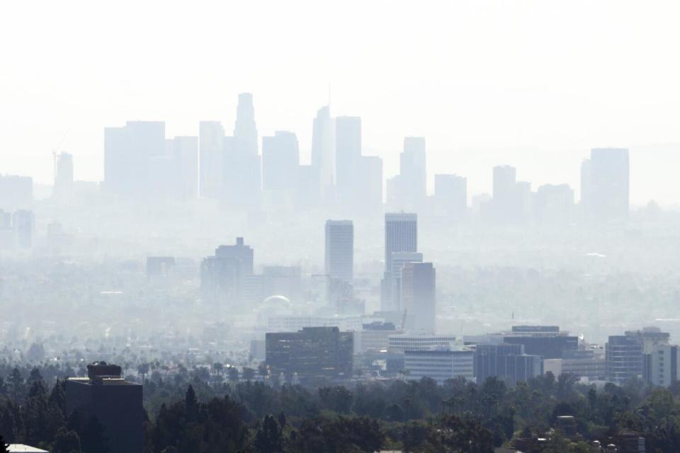 The downtown Los Angeles skyline is shrouded in haze.